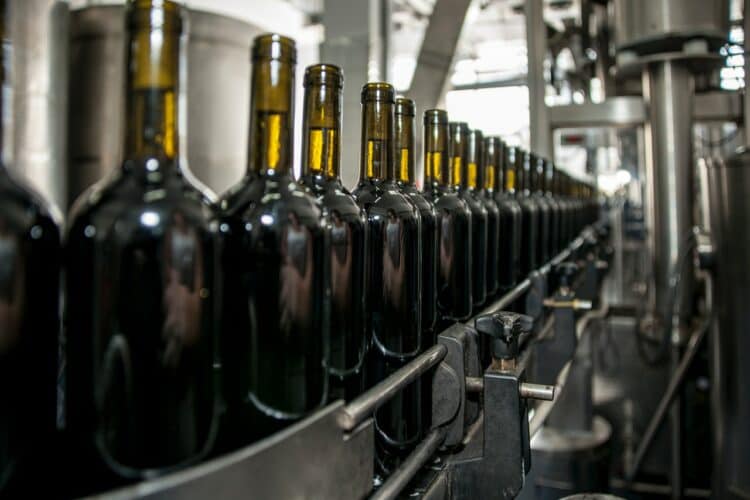 Photo by Lucian Pirvu: https://www.pexels.com/photo/wine-bottles-on-an-industrial-machinery-4176427/