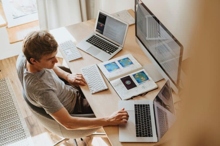 Photo by olia danilevich from Pexels: https://www.pexels.com/photo/man-using-3-computers-4974914/