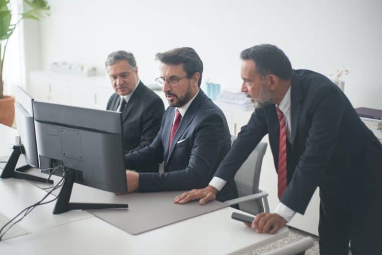 Photo by Kampus Production from Pexels: https://www.pexels.com/photo/three-men-in-black-suit-looking-at-computer-screen-8353776/