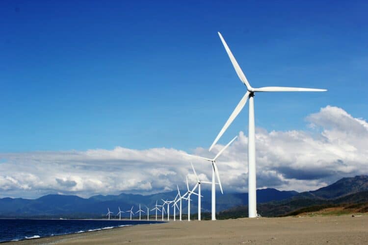 Photo by Kervin Edward Lara: https://www.pexels.com/photo/white-wind-turbines-on-gray-sand-near-body-of-water-3976320/