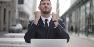 Photo by Andrea Piacquadio: https://www.pexels.com/photo/man-in-black-suit-sitting-on-chair-beside-buildings-3778966/