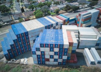 Photo by Kindel Media: https://www.pexels.com/photo/drone-shot-of-stacks-of-cargo-containers-9716376/
