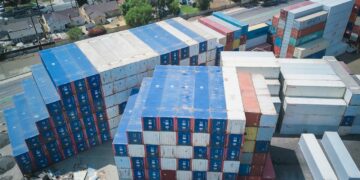 Photo by Kindel Media: https://www.pexels.com/photo/drone-shot-of-stacks-of-cargo-containers-9716376/