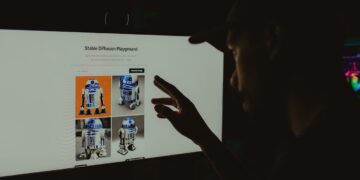 Photo by Alberlan  Barros: https://www.pexels.com/photo/man-hand-over-robot-on-screen-16018142/