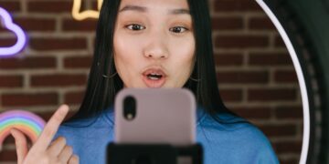 Photo by Ivan Samkov: https://www.pexels.com/photo/a-woman-recording-herself-with-a-smartphone-7676409/