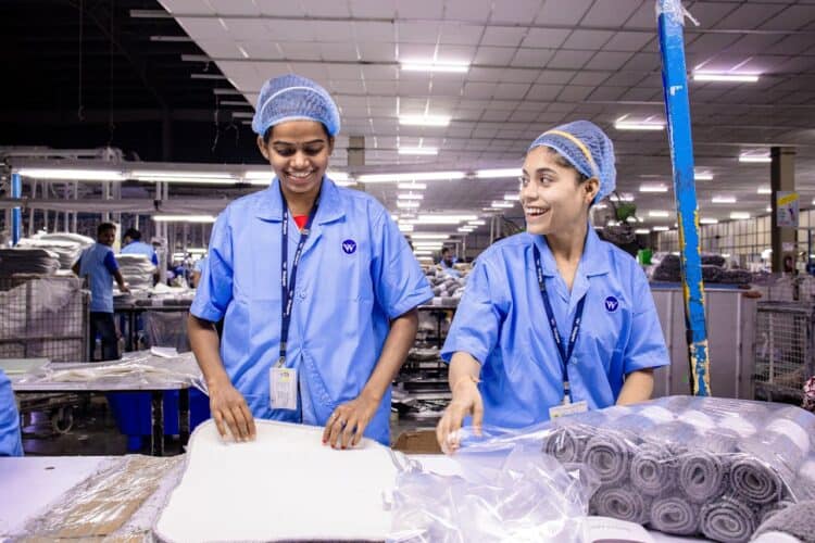 Photo by EqualStock IN: https://www.pexels.com/photo/smiling-factory-workers-in-a-textile-warehouse-31112188/