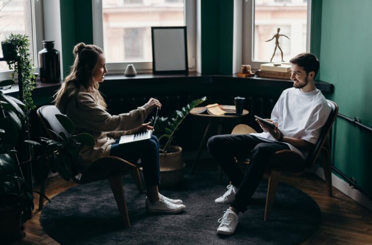 Photo by cottonbro studio: https://www.pexels.com/photo/man-and-woman-sitting-on-black-wooden-bench-4065146/