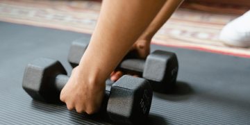 Photo by MART  PRODUCTION: https://www.pexels.com/photo/person-holding-black-dumbbells-8032759/