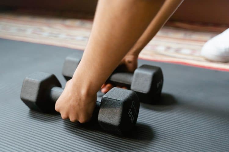 Photo by MART  PRODUCTION: https://www.pexels.com/photo/person-holding-black-dumbbells-8032759/