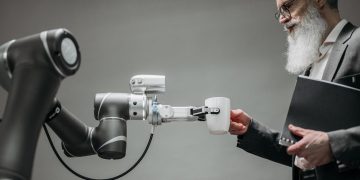Photo by Pavel Danilyuk: https://www.pexels.com/photo/a-robot-holding-a-cup-8439093/