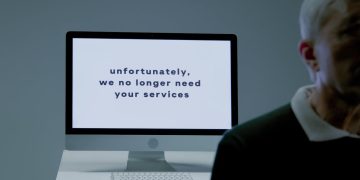 Photo by Ron Lach : https://www.pexels.com/photo/part-of-a-body-of-an-elderly-man-and-behind-screen-with-information-that-he-is-not-needed-anymore-9830817/