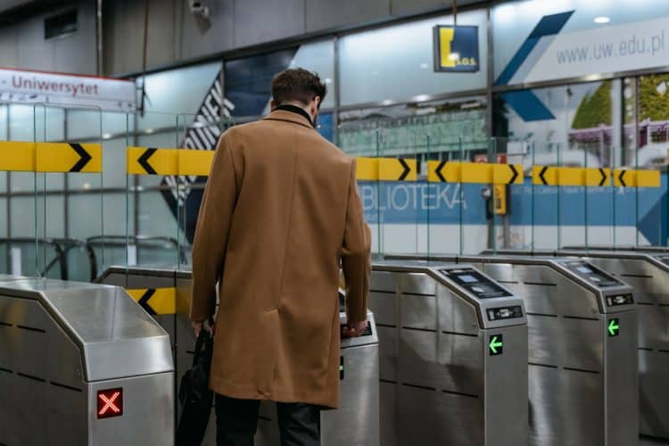 Photo by MART  PRODUCTION from Pexels: https://www.pexels.com/photo/a-person-in-brown-coat-entering-a-subway-automated-ticket-barrier-7251095/