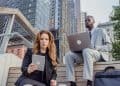 Photo by Mizuno K: https://www.pexels.com/photo/low-angle-shot-of-office-workers-sitting-on-wooden-steps-in-a-city-and-using-portable-devices-13801590/