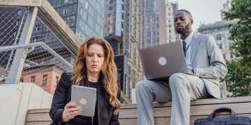 Photo by Mizuno K: https://www.pexels.com/photo/low-angle-shot-of-office-workers-sitting-on-wooden-steps-in-a-city-and-using-portable-devices-13801590/