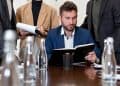 Photo by Mikhail Nilov: https://www.pexels.com/photo/businessman-in-suit-while-reading-a-book-8730174/