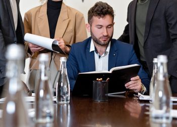 Photo by Mikhail Nilov: https://www.pexels.com/photo/businessman-in-suit-while-reading-a-book-8730174/