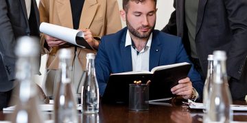Photo by Mikhail Nilov: https://www.pexels.com/photo/businessman-in-suit-while-reading-a-book-8730174/