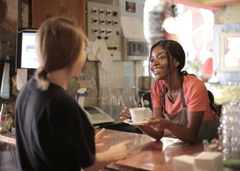 Photo by Andrea Piacquadio: https://www.pexels.com/photo/delighted-black-female-barista-serving-coffee-in-cup-in-cafe-3796810/
