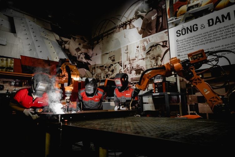 Photo by Hoang NC from Pexels: https://www.pexels.com/photo/men-in-protective-uniform-welding-with-robot-in-workshop-15888223/