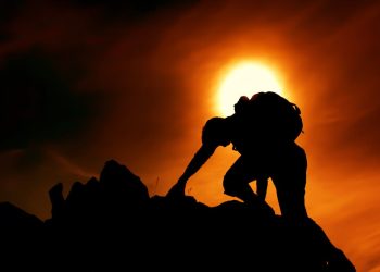 Photo by stein egil liland: https://www.pexels.com/photo/sun-over-silhouette-of-man-rock-climbing-20040806/