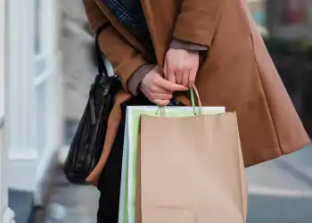Photo by Tim Douglas  from Pexels: https://www.pexels.com/photo/woman-in-coat-standing-with-paper-bags-in-hands-6567651/