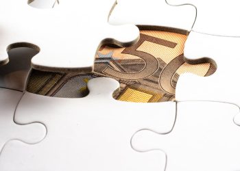 Photo by Mike van Schoonderwalt from Pexels: https://www.pexels.com/photo/money-under-a-white-puzzle-5484677/