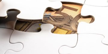 Photo by Mike van Schoonderwalt from Pexels: https://www.pexels.com/photo/money-under-a-white-puzzle-5484677/