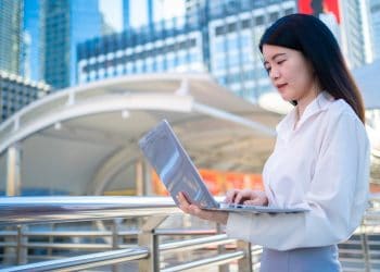 Photo by Sommart Sopon from Pexels: https://www.pexels.com/photo/asian-businesswoman-working-on-laptop-outdoors-35764294/