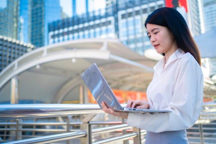 Photo by Sommart Sopon from Pexels: https://www.pexels.com/photo/asian-businesswoman-working-on-laptop-outdoors-35764294/