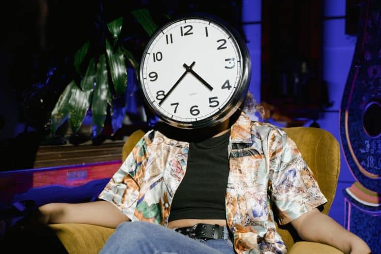 Photo by Tima Miroshnichenko from Pexels: https://www.pexels.com/photo/a-round-wall-clock-covering-the-person-face-8327546/